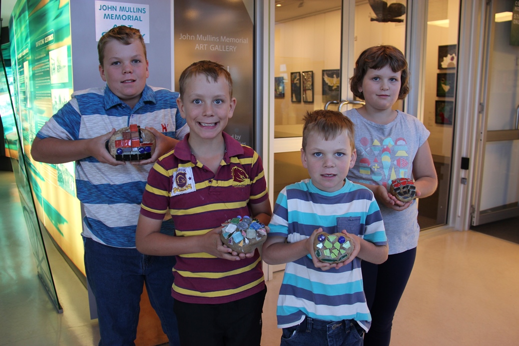 Group of 4 children showing their artwork